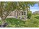 Beautiful front porch featuring stone columns and decorative railing, surrounded by green lawn and mature landscaping at 19552 Wagon Trail Dr, Noblesville, IN 46060