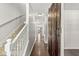 Inviting hallway with hardwood floors, white trim, and a unique sliding barn door accent at 19552 Wagon Trail Dr, Noblesville, IN 46060
