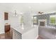 Granite-topped kitchen island is the focal point between the kitchen and living room fireplace at 19552 Wagon Trail Dr, Noblesville, IN 46060