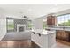 Open concept living room, with modern kitchen island, decorative fireplace, and ample natural light at 19552 Wagon Trail Dr, Noblesville, IN 46060