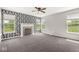 Living room has a black and white patterned wall, fireplace and three windows with green view at 19552 Wagon Trail Dr, Noblesville, IN 46060