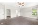 Spacious main bedroom with a walk-in closet, carpet floors, a ceiling fan, and natural light at 19552 Wagon Trail Dr, Noblesville, IN 46060