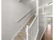 Carpeted stairway with white railing leads to the upper level of this well-maintained home at 19552 Wagon Trail Dr, Noblesville, IN 46060