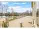 Expansive wooden deck overlooking a scenic lake view with decorative railings at 2001 E Ely Ct, Martinsville, IN 46151