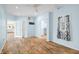 A spacious bedroom featuring wood floors, blue walls, an open doorway and windows with curtains at 2001 E Ely Ct, Martinsville, IN 46151