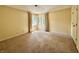 A light-filled bedroom features a corner window with curtains and plush carpeting at 2001 E Ely Ct, Martinsville, IN 46151