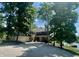 Beautiful home exterior with a large driveway, lush landscaping, and lake access at 2001 E Ely Ct, Martinsville, IN 46151