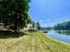 Scenic waterfront view of the property with a lakeside lawn and dock at 2001 E Ely Ct, Martinsville, IN 46151