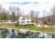A lakeside home featuring an expansive deck, a boat dock, and a picturesque view of the surrounding water at 2001 E Ely Ct, Martinsville, IN 46151