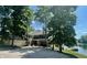 Beautiful home exterior with a large driveway, lush landscaping, and lake access at 2001 E Ely Ct, Martinsville, IN 46151