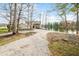 Charming home nestled among mature trees with a gravel driveway and serene lake views at 2001 E Ely Ct, Martinsville, IN 46151