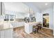 Well-lit kitchen featuring white cabinets, stainless steel appliances, and a stylish breakfast bar with pendant lighting at 2001 E Ely Ct, Martinsville, IN 46151