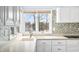 Bright kitchen with white cabinets, modern appliances, and a beautiful view of the lake at 2001 E Ely Ct, Martinsville, IN 46151