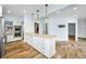 Spacious kitchen with white cabinets, an island with bar seating, and modern appliances for easy meal preparation at 2001 E Ely Ct, Martinsville, IN 46151