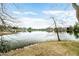 Picturesque lake view with mature trees creating a serene and natural setting for this beautiful property at 2001 E Ely Ct, Martinsville, IN 46151