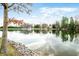 Beautiful lake view featuring mature trees, blue skies, and a charming home along the water at 2001 E Ely Ct, Martinsville, IN 46151