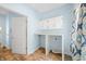 Charming laundry room featuring blue walls, a utility sink, a white hanging cabinet, and washer dryer hookups at 2001 E Ely Ct, Martinsville, IN 46151