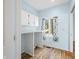 Bright laundry room featuring built-in cabinets, a countertop, and a window with scenic outdoor views at 2001 E Ely Ct, Martinsville, IN 46151