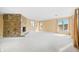 Spacious living room with stone fireplace, neutral carpet, and large windows with natural light at 2001 E Ely Ct, Martinsville, IN 46151