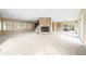 Open-concept living room featuring a stone fireplace, large windows, and carpet for a cozy and inviting atmosphere at 2001 E Ely Ct, Martinsville, IN 46151