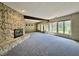 Open living room features a stone fireplace and views of the water at 2001 E Ely Ct, Martinsville, IN 46151