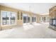 Bright living room featuring large windows, sliding glass doors, and a stone fireplace at 2001 E Ely Ct, Martinsville, IN 46151
