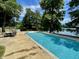 Beautiful pool with lake views, surrounded by mature trees and landscaping at 2001 E Ely Ct, Martinsville, IN 46151