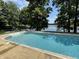 Swimming pool with lakeside views, surrounded by mature trees and landscaping at 2001 E Ely Ct, Martinsville, IN 46151
