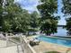 An in-ground swimming pool surrounded by green trees offers private relaxation at 2001 E Ely Ct, Martinsville, IN 46151