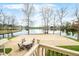 Outdoor patio with a dining set overlooking a covered pool and serene lake views; perfect for entertaining at 2001 E Ely Ct, Martinsville, IN 46151