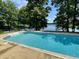 Sparkling pool with lakeside views, steps, and decorative tile border at 2001 E Ely Ct, Martinsville, IN 46151