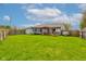 Spacious backyard with a deck, trampoline, shed, and well-maintained lawn at 2125 Jason Dr, Lebanon, IN 46052