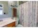 Bathroom featuring a sink, a toilet, and a shower with marble patterned shower curtain at 2125 Jason Dr, Lebanon, IN 46052
