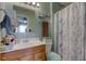 Bathroom featuring a sink, a toilet, and a shower with marble patterned shower curtain at 2125 Jason Dr, Lebanon, IN 46052