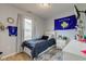 Cozy bedroom with modern decor, a comfortable bed, and a large window letting in natural light at 2125 Jason Dr, Lebanon, IN 46052
