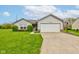 Charming single-story home featuring a two-car garage, well-maintained lawn, and lovely landscaping at 2125 Jason Dr, Lebanon, IN 46052
