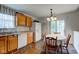 Eat-in kitchen offers stainless sink, white appliances, light wood cabinets, and sliding glass door to the outside at 2125 Jason Dr, Lebanon, IN 46052
