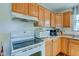 Close up of range and cabinets in kitchen with white appliances at 2125 Jason Dr, Lebanon, IN 46052