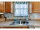 Close up of sink, stainless faucet, light wood cabinets, and neutral countertop in the kitchen at 2125 Jason Dr, Lebanon, IN 46052