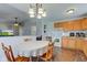 Bright eat-in kitchen offers wood cabinets and flooring, and is open to the living room at 2125 Jason Dr, Lebanon, IN 46052