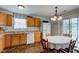 Eat-in kitchen offers stainless sink, white appliances, light wood cabinets, and sliding glass door to the outside at 2125 Jason Dr, Lebanon, IN 46052