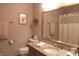 Neutral toned bathroom featuring a granite countertop, framed art, and wood framed mirror at 215 Fairway Ct, Franklin, IN 46131