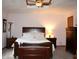 Primary bedroom with a wooden sleigh bed, neutral carpet and dark wood furniture at 215 Fairway Ct, Franklin, IN 46131