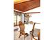 Cozy dining room with a round table, wooden chairs, and elegant chandelier beneath a wood paneled ceiling at 215 Fairway Ct, Franklin, IN 46131