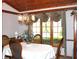 Well lit dining room with wainscotting, classic furniture and a beautiful bay window at 215 Fairway Ct, Franklin, IN 46131