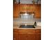 Updated kitchen showcasing wooden cabinets, stone countertops, and a modern stovetop at 215 Fairway Ct, Franklin, IN 46131