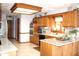Functional kitchen with oak cabinetry, granite countertops, and modern appliances at 215 Fairway Ct, Franklin, IN 46131