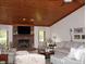 Inviting living room featuring a brick fireplace, wood-paneled ceiling, and comfortable seating at 215 Fairway Ct, Franklin, IN 46131