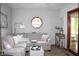 Neutral living room with comfortable seating, a floor lamp, an octagonal window and a sliding door to sunroom at 215 Fairway Ct, Franklin, IN 46131