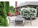 Inviting patio with outdoor seating, manicured greenery, and flowering bushes, perfect for relaxing or entertaining at 215 Fairway Ct, Franklin, IN 46131